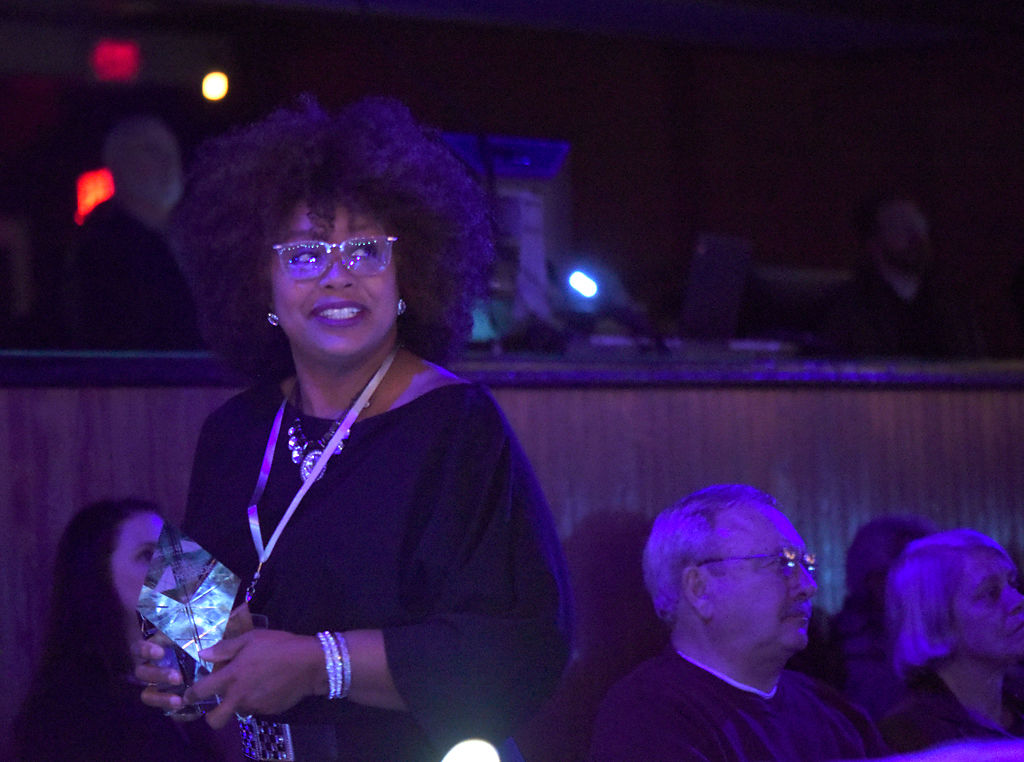 Verna Laboy returns to her seat after winning the award for Progress in Health Care